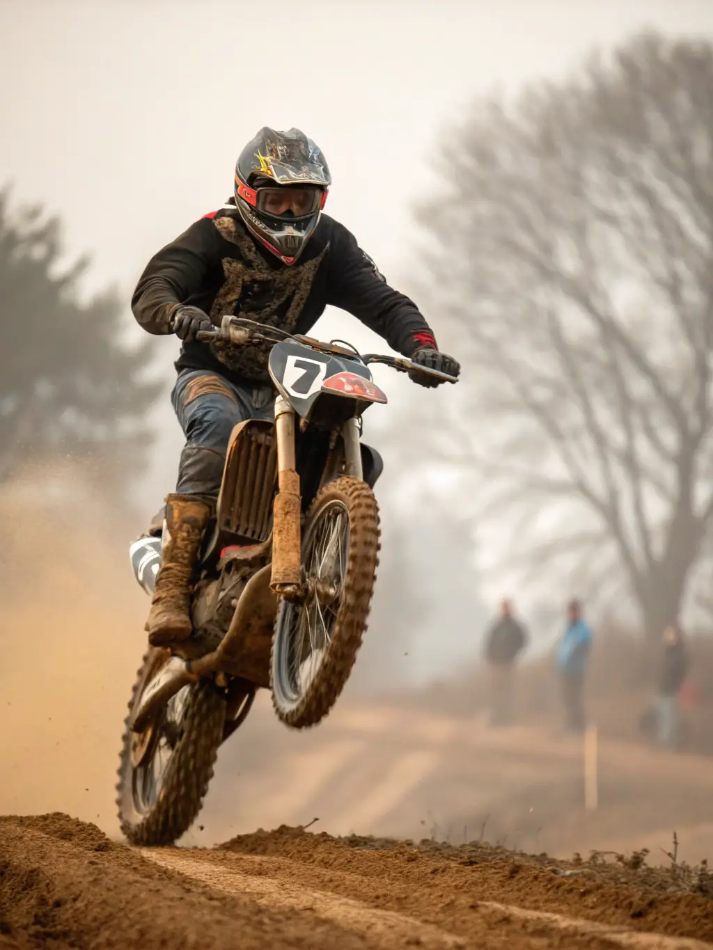 A young motocross rider in full gear skillfully navigating a turn on a dirt track during a training session at MOTO CLUB DE PRANZAC. The image captures the intensity and focus of the rider, with dust kicking up behind the bike.