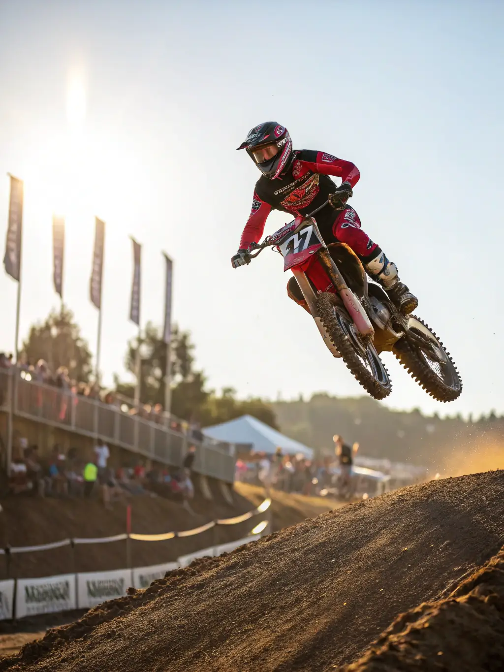 A high-action shot of a motocross rider skillfully navigating a jump on a dirt track during a training session at MOTO CLUB DE PRANZAC, showcasing the intensity and excitement of the sport.